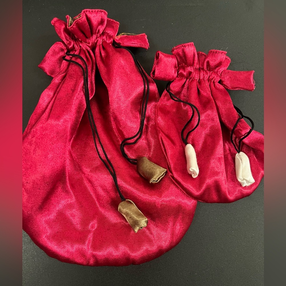 Pink/red satin drawstring pouches.